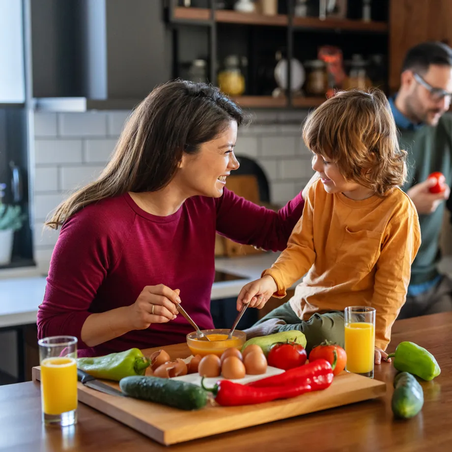 Family cooking together in a clean kitchen