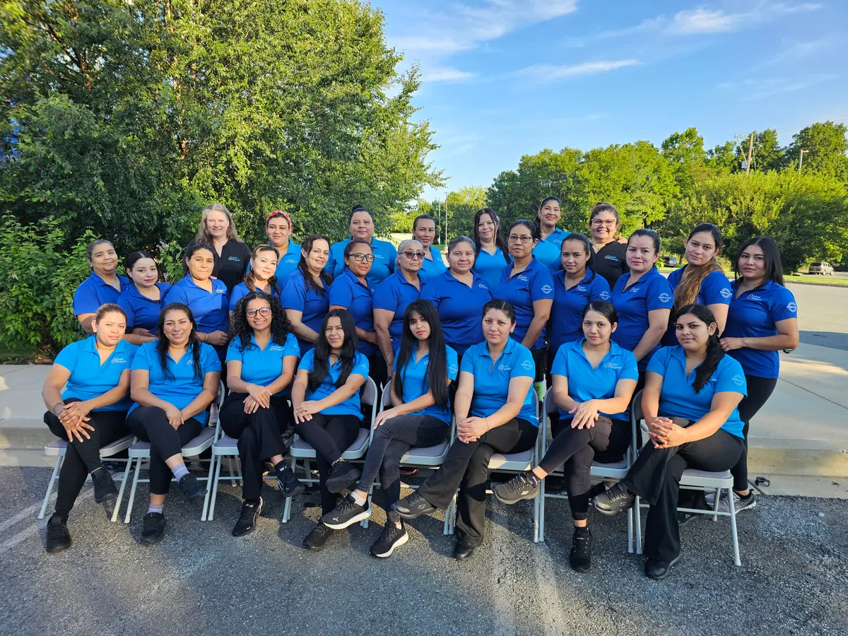 The Maid Brigade team &mdash; office staff and cleaning professionals &mdash; gathered outside our office