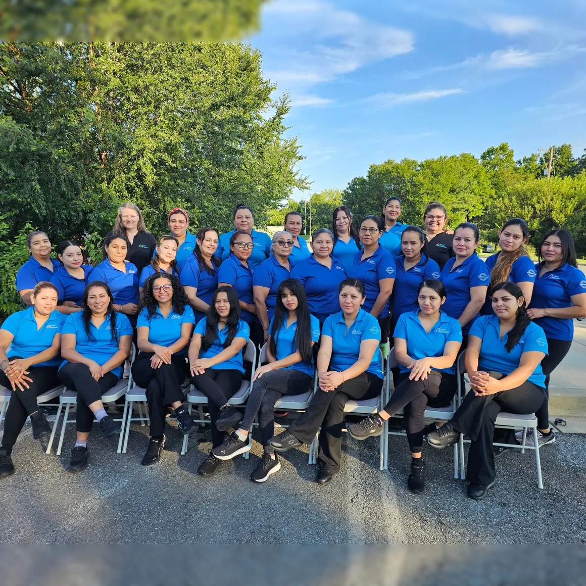 The full Maid Brigade team &mdash; nearly 30 cleaning professionals and office staff &mdash; gathered outside the office